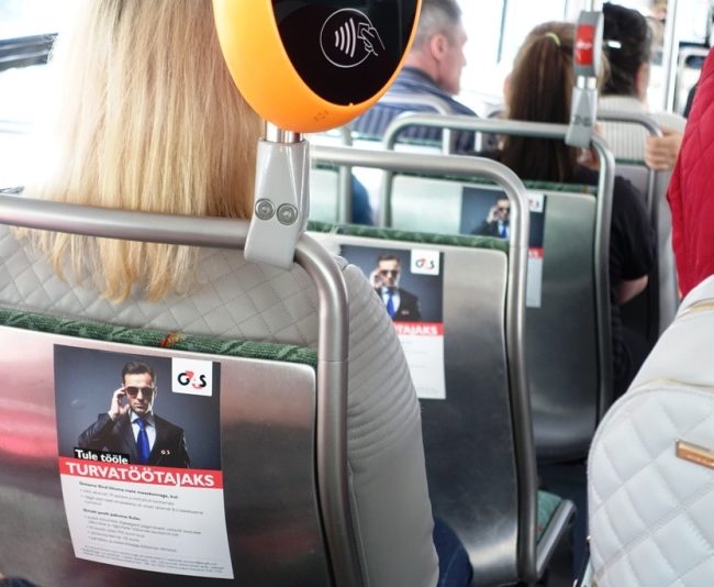 G4S – reklaam bussis, istmete seljatugedel